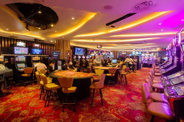 A close-up shot of golden coins falling around a spinning roulette wheel, representing immersive casino action at 26JLPH.